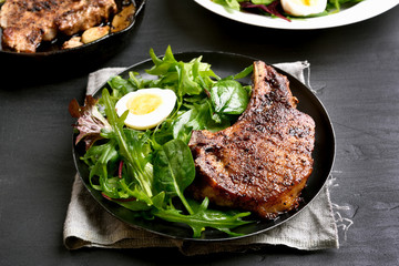 Cooked pork steak with green salad