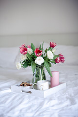Romantic breakfast in bed. Bouquet of flowers. Roses and tulips. Spring. Valentine's Day. International Women's Day. Cozy.