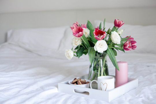 Romantic breakfast in bed. Bouquet of flowers. Roses and tulips. Spring. Valentine's Day. International Women's Day. Cozy.
