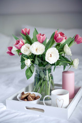 Romantic breakfast in bed. Bouquet of flowers. Roses and tulips. Spring. Valentine's Day. International Women's Day. Cozy.