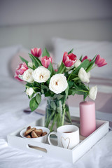 Romantic breakfast in bed. Bouquet of flowers. Roses and tulips. Spring. Valentine's Day. International Women's Day. Cozy.