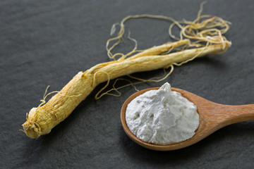 Radix Ginseng root next to White rice and Chinese Ginseng clarifying polishing facial mask in wooden spoon © sasimoto