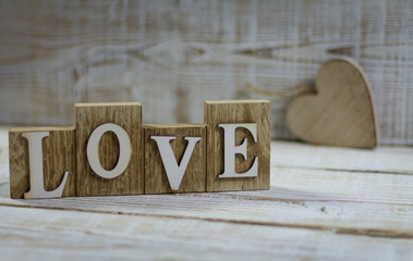 Signature love on a wooden background. Valentine's Day