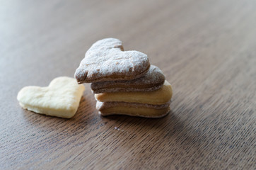 Close-up of cookies in the shape of a heart lying on the wooden table background