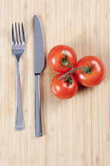 Red fresh tomatoes on chopping board