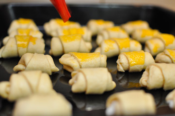 Rolls in baking tray ready for baking . Making domestic rolls with cheese