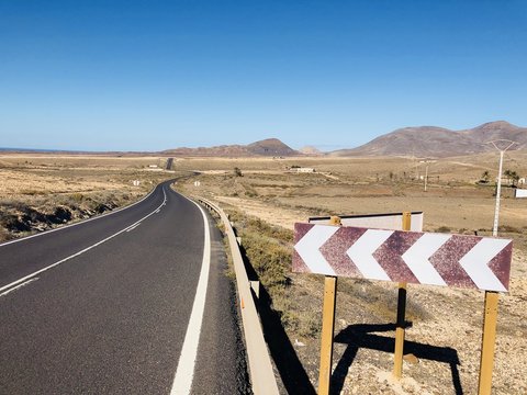 Chevron signs on a road, Fuerteventura, Las Palmas, Canary Islands, Spain