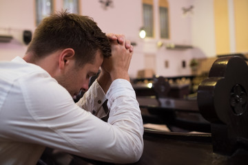 caucasian man praying in church. He has problems and ask God for help © RealPeopleStudio