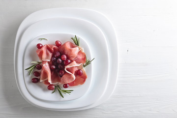 Jamon serrano with rosemary and grape .