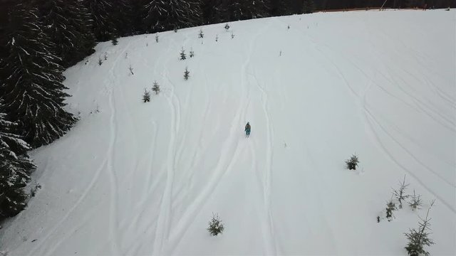 A young guy is riding a ski down the alpine slope