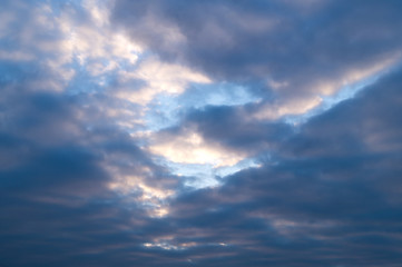 Obraz premium Dark stormy clouds on the blue sky at sunset or sunrise