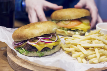 Meat burgers with onion, cheese and fries