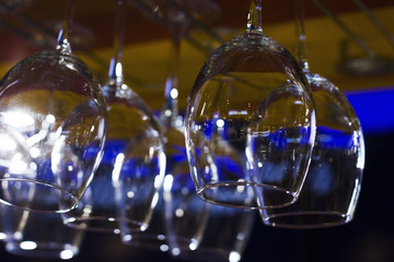 The empty clean glasses in bar, upside down, close up