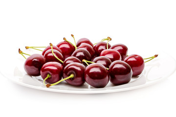 Cherry berries on a white plate isolated on white background cutout