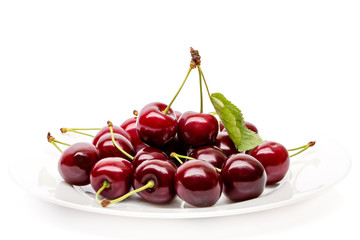 Cherry berries on a white plate isolated on white background cutout