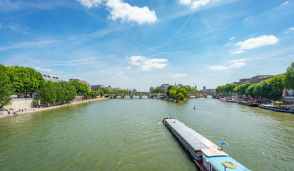 Long boat over Seine river near Notre Dame island in Paris