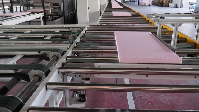 transportation of polystyrene along assembly belt line at plant, close-up