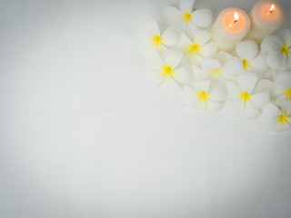 spa wellness set.beauty and fashion set on the white table.spa towel with candle and plumeria, tree on the white table.
