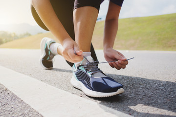 Fototapeta na wymiar Healthy fitness athlete woman preparing jogging at a outdoor park