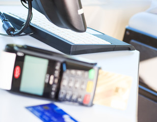 Hand using a credit card terminal machine for payment in the dining room and supermarket, calculation on the Internet