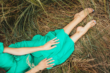 The future mother sitting on the grass