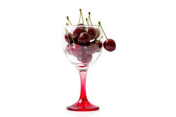 Cherries in an empty wine glass. Isolated on white background
