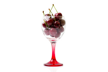 Cherries in an empty wine glass. Isolated on white background
