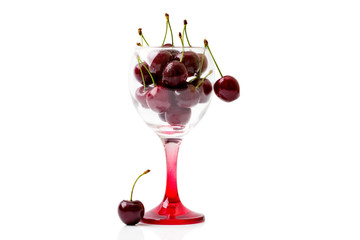Cherries in an empty wine glass. Isolated on white background