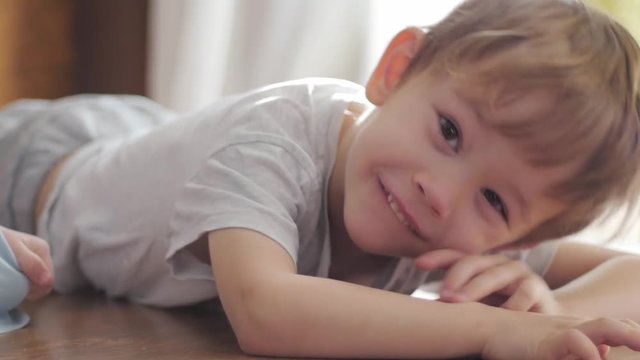 cute boy lying on the floor looking at camera, portrait