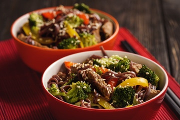 Brown rice noodles with meat and vegetables, oriental style cuisine.