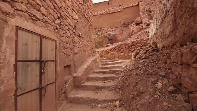 Personal view of walking in desert scenic city Ait-Ben-Haddou Castle in Morocco, exterior in movie Game of Thrones, Steady cam shot