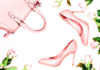 Pastel pink women high heel shoes and bag on pink background. Flat lay, top view trendy fashion feminine background. Beauty blog concept. Fashion blog look.