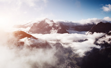 Creamy fog covered the glacier Marmolada. Location place Val di Fassa valley, passo Sella, Dolomiti, Italy.