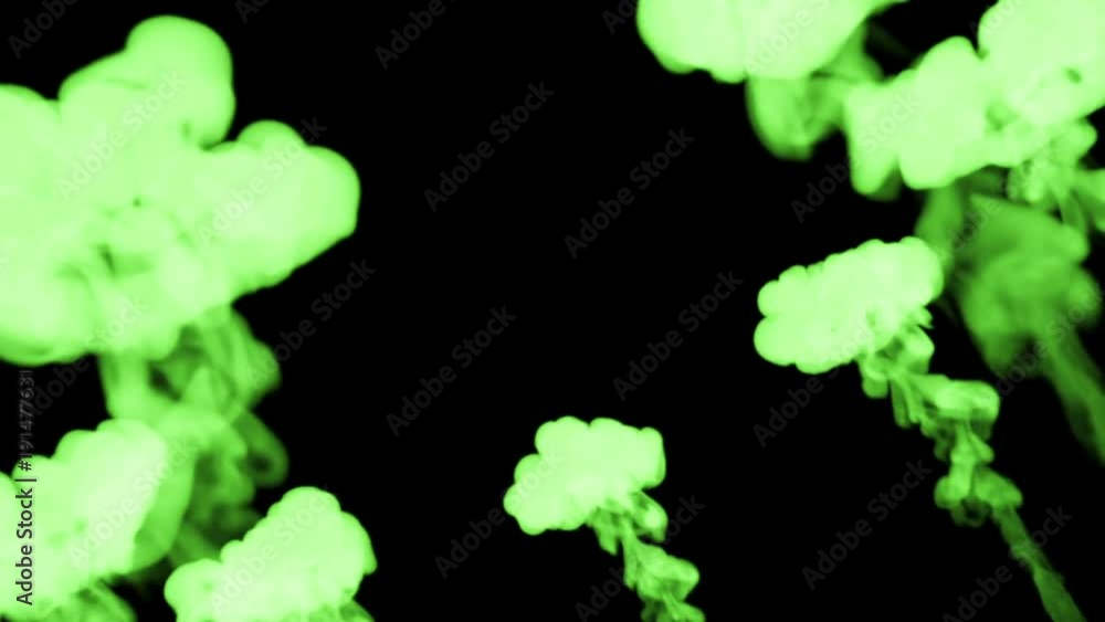 Poster circular streams of fluorescent green ink on a black background dissolves in the water from the bott