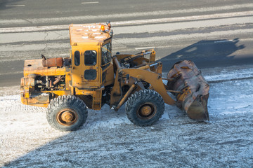 Tractor clears the way after snowfall.