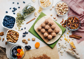 Сandies from dried fruits, nuts and chickpeas covered with cocoa powder and coconut chips