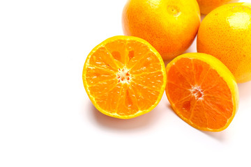 Fresh orange cut in half on a white background.