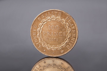 a gold antique coin of 100 francs in 1879 with the inscription freedom, equality, fraternity. Republic of France