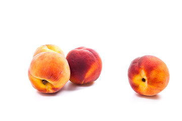 Group of ripe peach fruit isolated on white background.