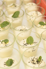 caterer preparing a bunch of little dessert glasses