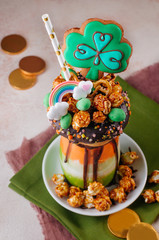 Color freak shake topping with clover cookie on beige background