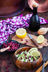 Delicious healthy cous cous salad with herbs, lemon zest, feta cheese and pomegranate seeds