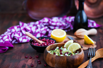 Delicious healthy cous cous salad with herbs, lemon zest, feta cheese and pomegranate seeds