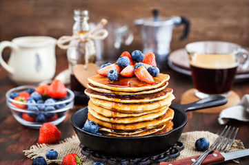 Stack of freshly prepared banana  pancakes with fresh berries