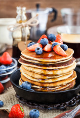 Stack of freshly prepared banana  pancakes with fresh berries