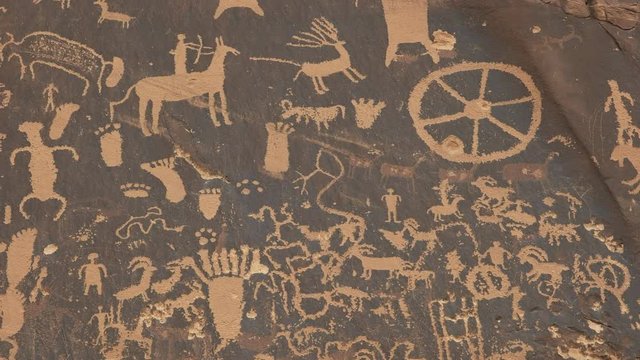 tilt up shot of ancient american indian art on newspaper rock at canyonlands national park in utah, usa