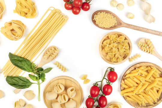 Overhead photo of different types of pasta on white, forming frame