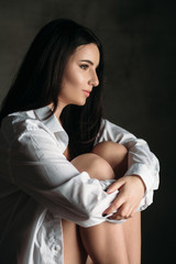 Obraz premium The beautiful girl sits on the chair