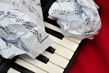 crumpled sheet music lying