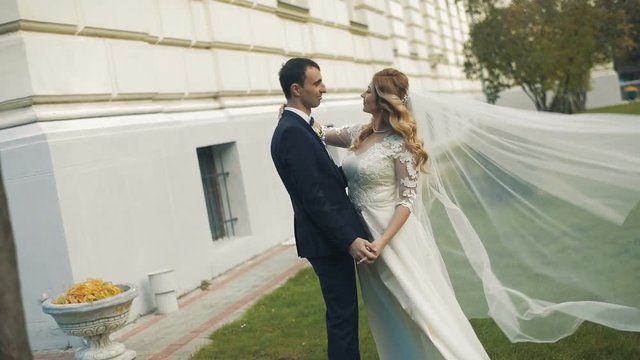 A young and beautiful wedding couple making a kiss. Slow motion